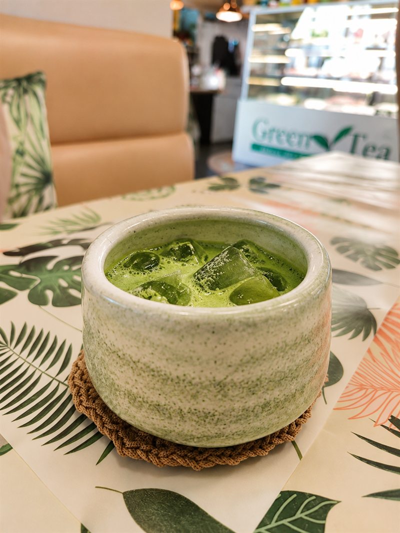 Iced matcha latte in a handmade ceramic cup